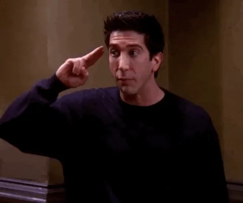 Reaction gif of a man in a dark sweater tapping his temple, a nudge to think before straying from your niche.